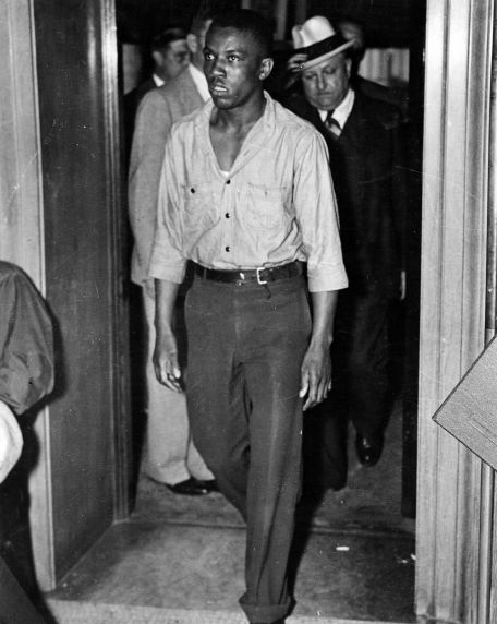 An African American man enters the courtroom during the National Labor Relations Bureau inquiry into the Battle of the Overpass. 