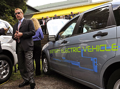 In this file photo, Chairman Bill Ford is interviewed with a Ford Focus Battery Electric Vehicle during the 2009 Mackinac Policy Conference in Mackinac Island, Mich. Ford says its future electric cars will "talk" to power grids across the country, part of an effort to drive interest in alternative energy vehicles. 