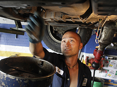 Napa AutoPro store mechanic Roy Yu works on a car Aug. 18, 2009, at the AutoPro shop at 1520 Warden Avenue in Scarborough.
