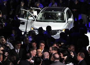 Ford CEO Alan Mulally is surrounded by reporters near the 2011 Lincoln MKX during the press preview at the auto show at Cobo Center. (Daniel Mears / The Detroit News)