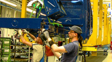 Workers assemble a vehicle at Ludwigsvelde Daimler-Mercedes plant. Doug Saunders/The Globe and Mail