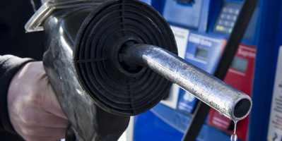 A man replaces the nozzle after filling up at a gas station Wednesday in Montreal. The price of oil has been climbing as turmoil in Libya fuels fears that unrest could spread to other oil-producing nations and choke supplies.