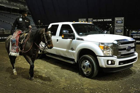 Mike White, in town for tonight’s Professional Bull Riders competition, rides around the new 2013 Ford F-450 Platinum on Friday at Ford Field where Ford introduced the 2013 F-Series Super Duty truck models. (Daniel Mears / The Detroit News)