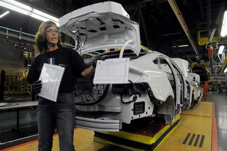 Trainer Susan Spaulding holds an instruction sheet used by trainees to install parts on July 31, during a demonstration at the Ford Flat Rock Plant in Flat Rock. (Steve Perez/The Detroit News)