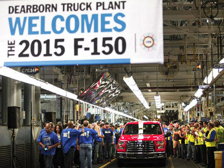 Autoworkers applaud and take photos of the first all-new 2015 Ford F-150 truck as it comes off the assembly line at the Ford Dearborn Truck Plant Nov. 11, 2014 in Dearborn, Mich.. The new 2015 F-150 is the first mass-produced truck in its class featuring a high-strength, military-grade, aluminum-alloy body and bed. (Photo: Bill Pugliano/ Getty Images)