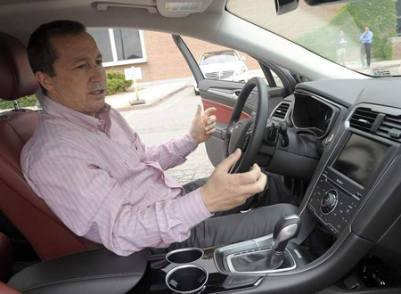 Larry Kummer, manager of vehicle integration for Ford Motor Co., checks the DNA of a Fusion. (Clarence Tabb Jr. / The Detroit News)