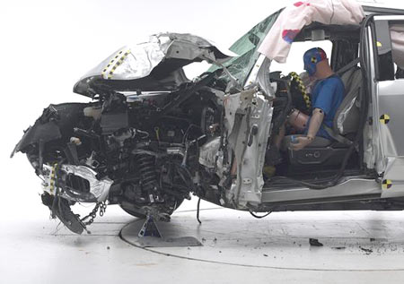 2015 Ford F-150 extended cabafter the small overlap crash test. The dummy's position in relation to the door frame, steering wheel, and instrument panel after the crash test indicates that the driver's survival space wasn't maintained well. (Photo: Photos by Insurance Institute for Highway Safety)