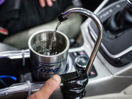 Ford’s prototype On-the-Go H2O system collects, filters and pumps water directly to a faucet hanging over the cupholders. (Photo: Ford Motor Co.)