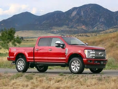 A 2017 Ford F-250 Platinum Super Duty Crew Cab poses for a shot in front of Colorado mountains.  Image courtesy Ford Motor Co.