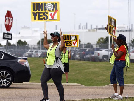 United Auto Workers members set up an informational line outside this employee entrance at the Nissan vehicle assembly plant in Canton, Miss., Tuesday, Aug. 1, 2017. Most shifts arriving and leaving were met with posters, flyers and union chants at each of the plant's employee entrances. The UAW has a vote scheduled Aug. 3-4, on whether it should represent the 3,700 full time company employees. (AP Photo/Rogelio V. Solis)
