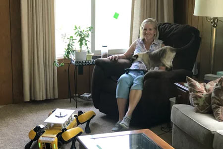 Paula Wiebelhaus is training Fluffy the robotic dog at home for Ford during the pandemic. Her cats are wary of the machine. (Photo: Courtesy Paula Wiebelhaus)
