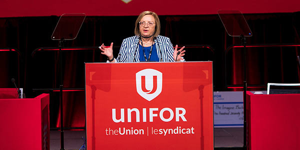 Unifor National President Lana Payne standing a the podum during the Constitutional Convention.
