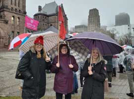 Tracey Ramsey, Gwen Campbell and Niki Lundquist stand in front of Queen’s Park.
