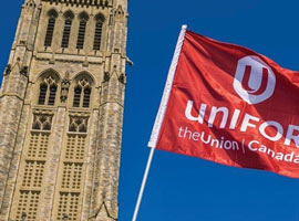 Unifor flag flying in front of Parliament Hill's Peace Tower 