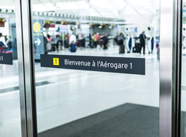 Glass sliding doors peering into an airport terminal 