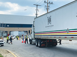 A Hudson's Bay Company transport truck outside of a warehouse